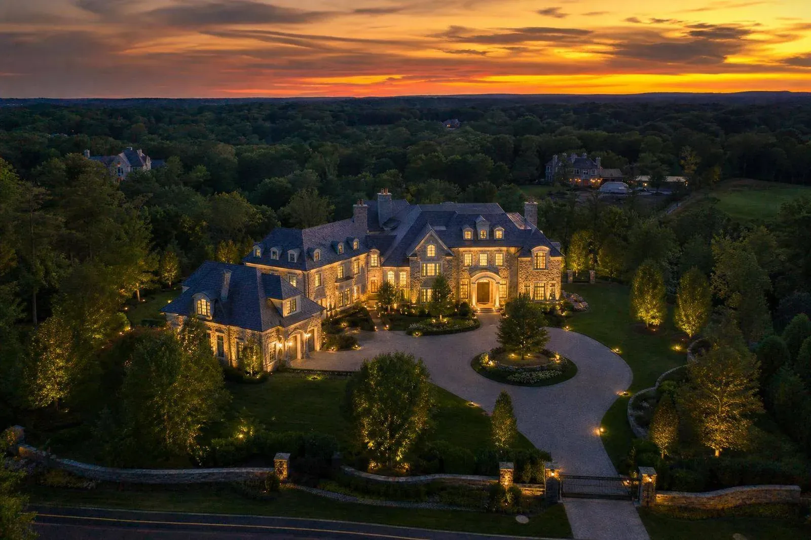 Aerial twilight view of a large custom estate home in Hockessin, Delaware
